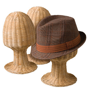 Multiple wicker heads and one with a brown hat